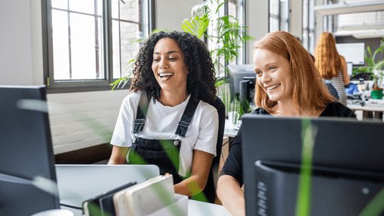 Two women showing ways to stay happy at work