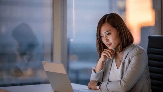 Woman-working-at-desk-late-into-the-evening-poor-work-life-balance.png