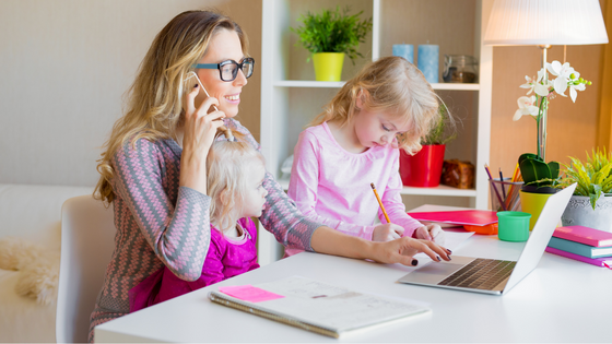 Woman-sat-at-desk-working-alongside-daughters-work-life-balance.png
