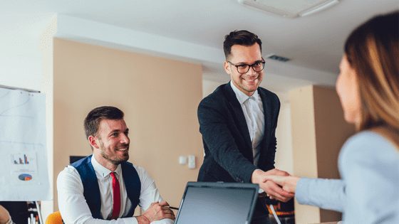 Man and woman shaking hands showing integrity in the workplace