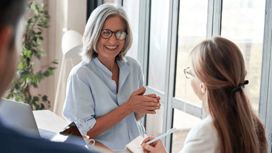 Grey-haired lady being subjected to unconscious bias in the workplace