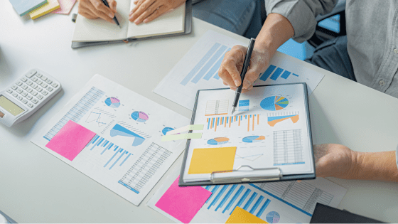 Two managers sat at a desk reviewing performance for employees to work flexibly.